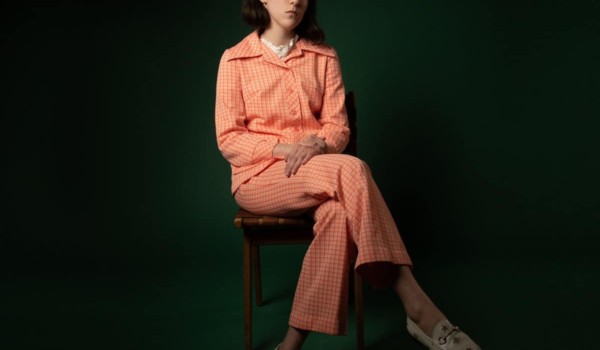 Alannah Kavanagh of Grizzly Coast sitting on a stool with her legs crossed