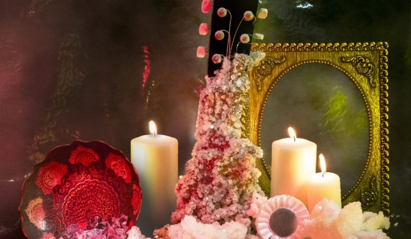 Cover for Sam Coffey and the Iron Lungs album 'Real One'. A guitar neck encrusted with diamonds surrounded by flowers and candles. Dimly lit.