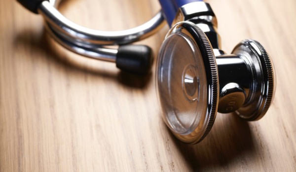 Jessica Evans on prison health as public health. Photo of stethoscope resting on tabletop.