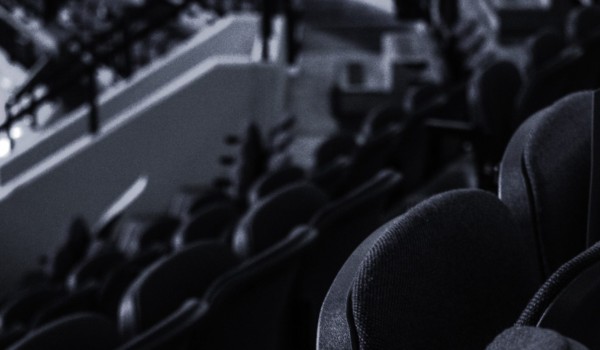 Why the NWHL Bubble burst. Black and white photo of empty hockey stadium.