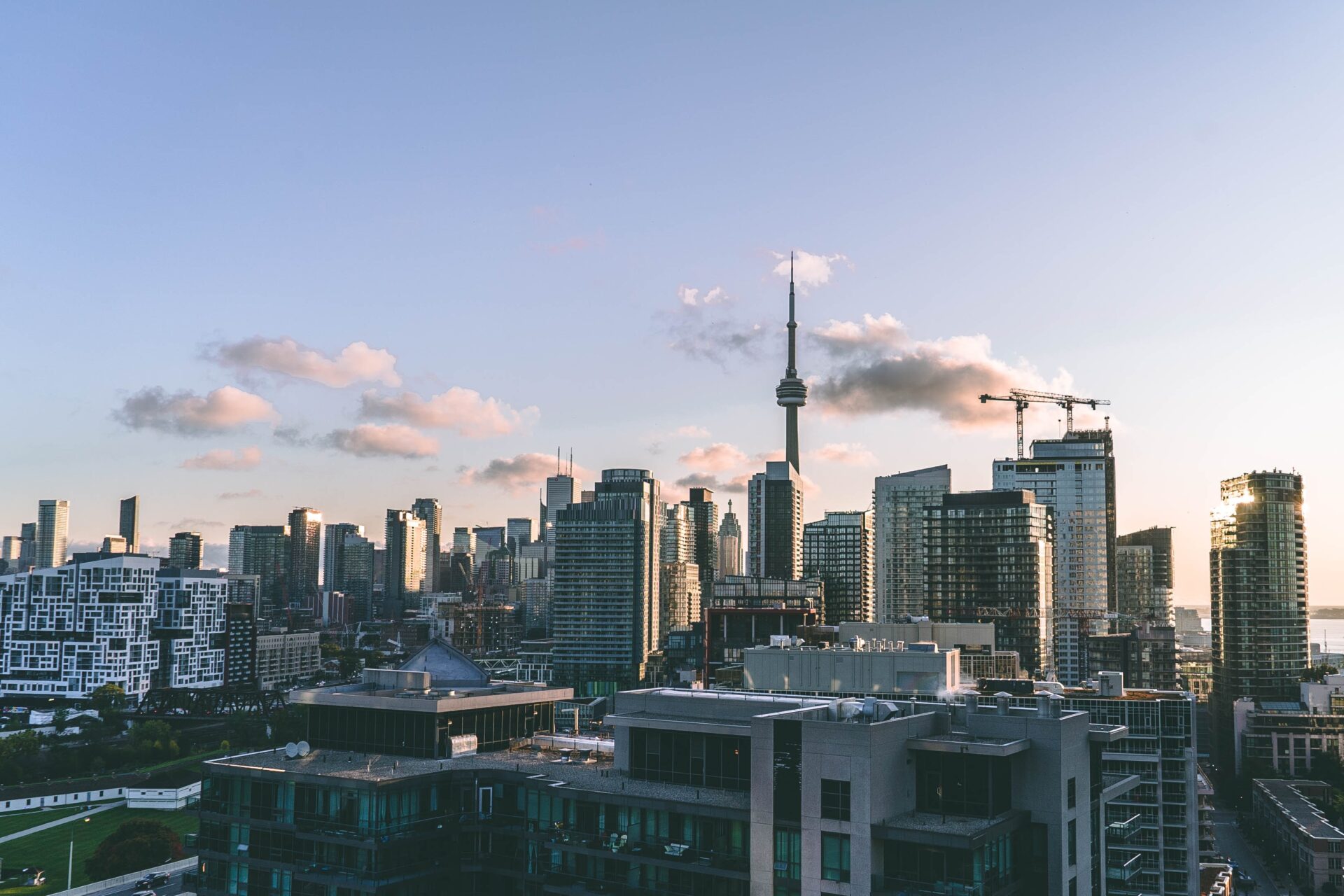 Buildings against a blue sky background with several clouds in the distance.