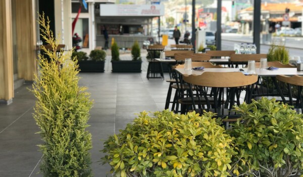 A row of tables outside a restaurant