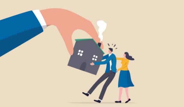 A cartoon drawing of a large hand taking a house away from two smaller people