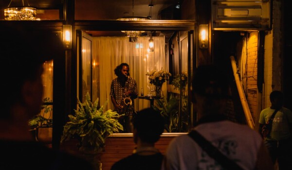 A jazz musician plays in a storefront