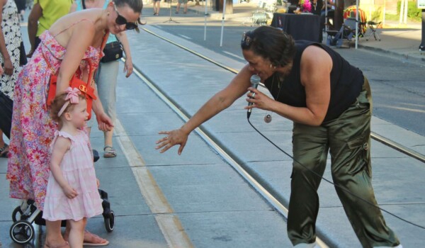 A jazz musician reaches out to a young girl in the audience