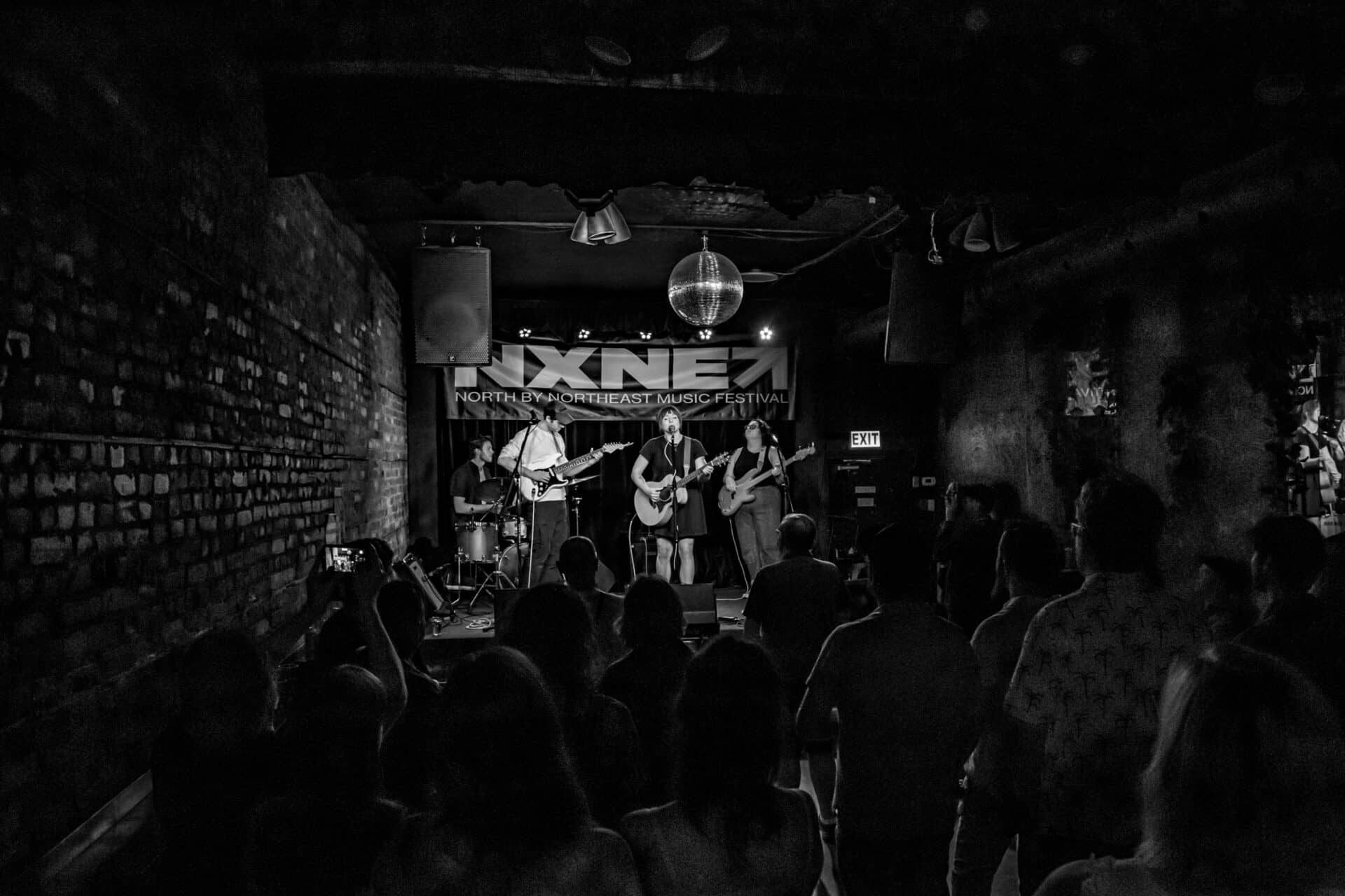 Alanna Matty and band performing to a packed crowd.