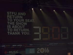 A display on the backdrop of the stage at Polaris Prize 2016, saying "STFU and return to your seat the show is about to return thank you."